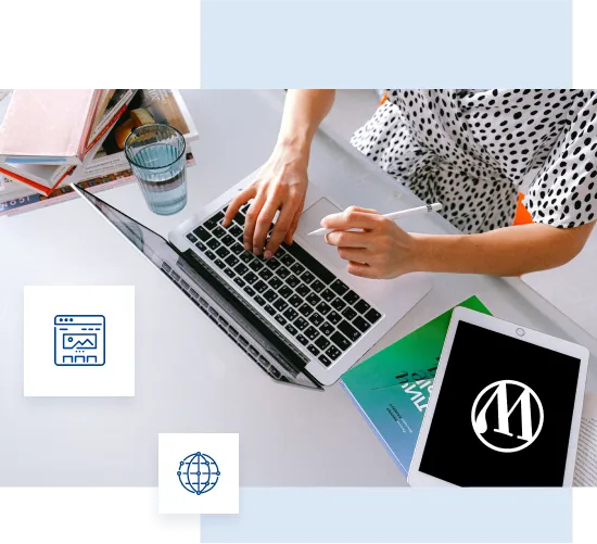 Picture showing a woman's hands placed on a computer keyboard and next to it a tablet with a Wordpress logo on the desktop.